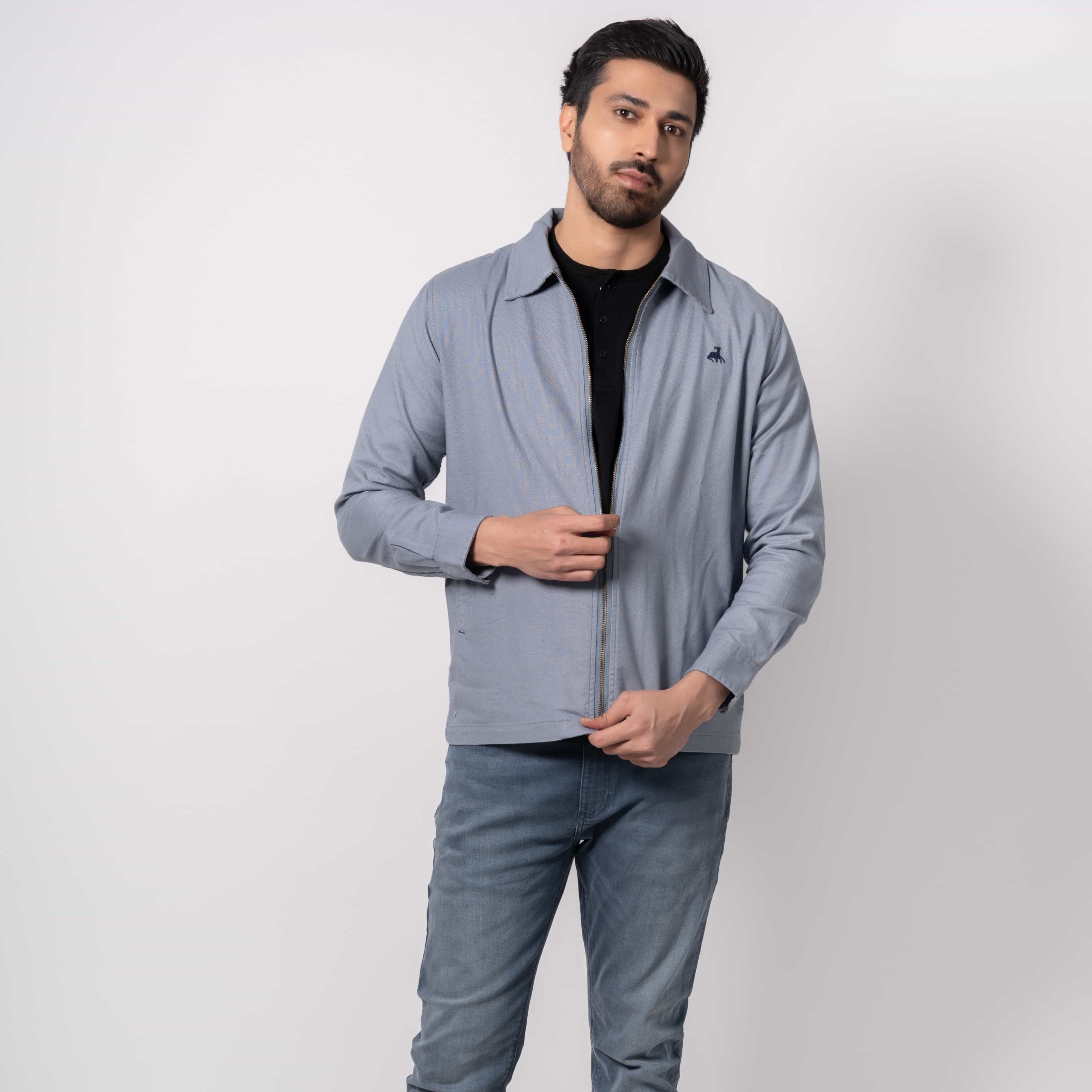 Man wearing a light gray jacket and pants on a white background