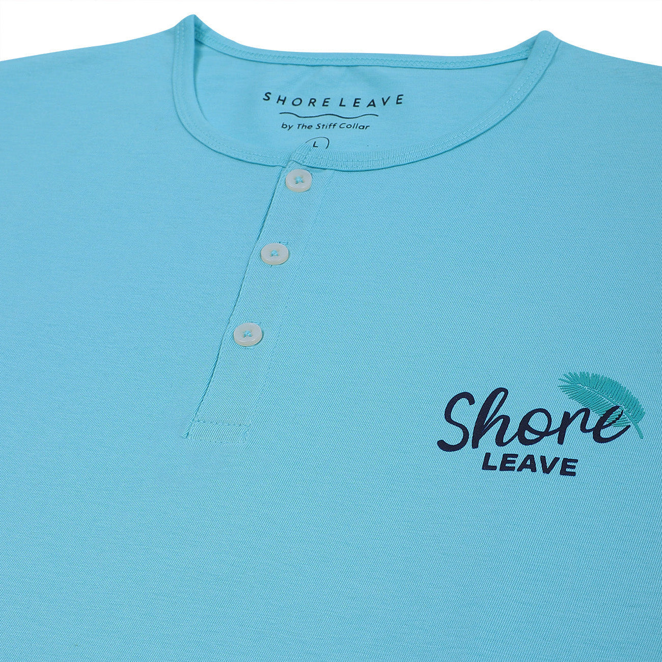 Light blue shirt with 'Shore Leave' text and logo on a white background